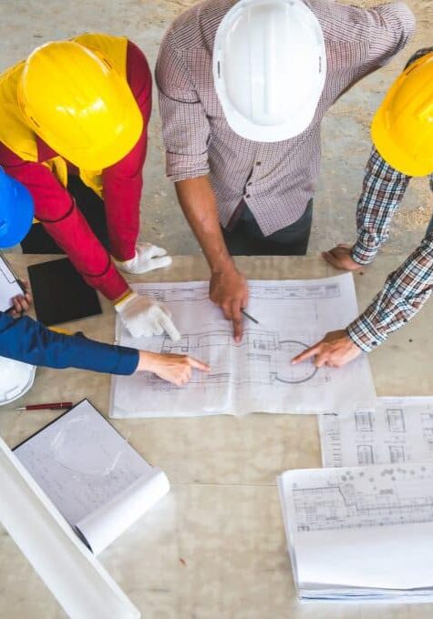 Engineer and foreman meeting at site with blueprint